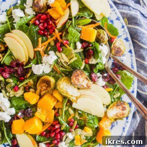 Fall harvest salad recipe in a large serving plate with a large spoon inside.
