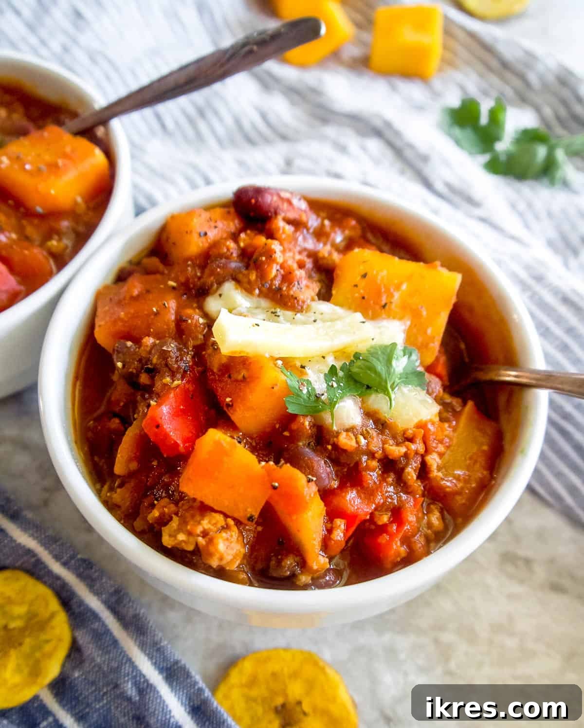 Hearty Turkey Chili with Butternut Squash and Black Beans 9 A delicious bowl of turkey black bean butternut squash chili, garnished with a spoon, inviting you to dig in and enjoy the hearty meal.