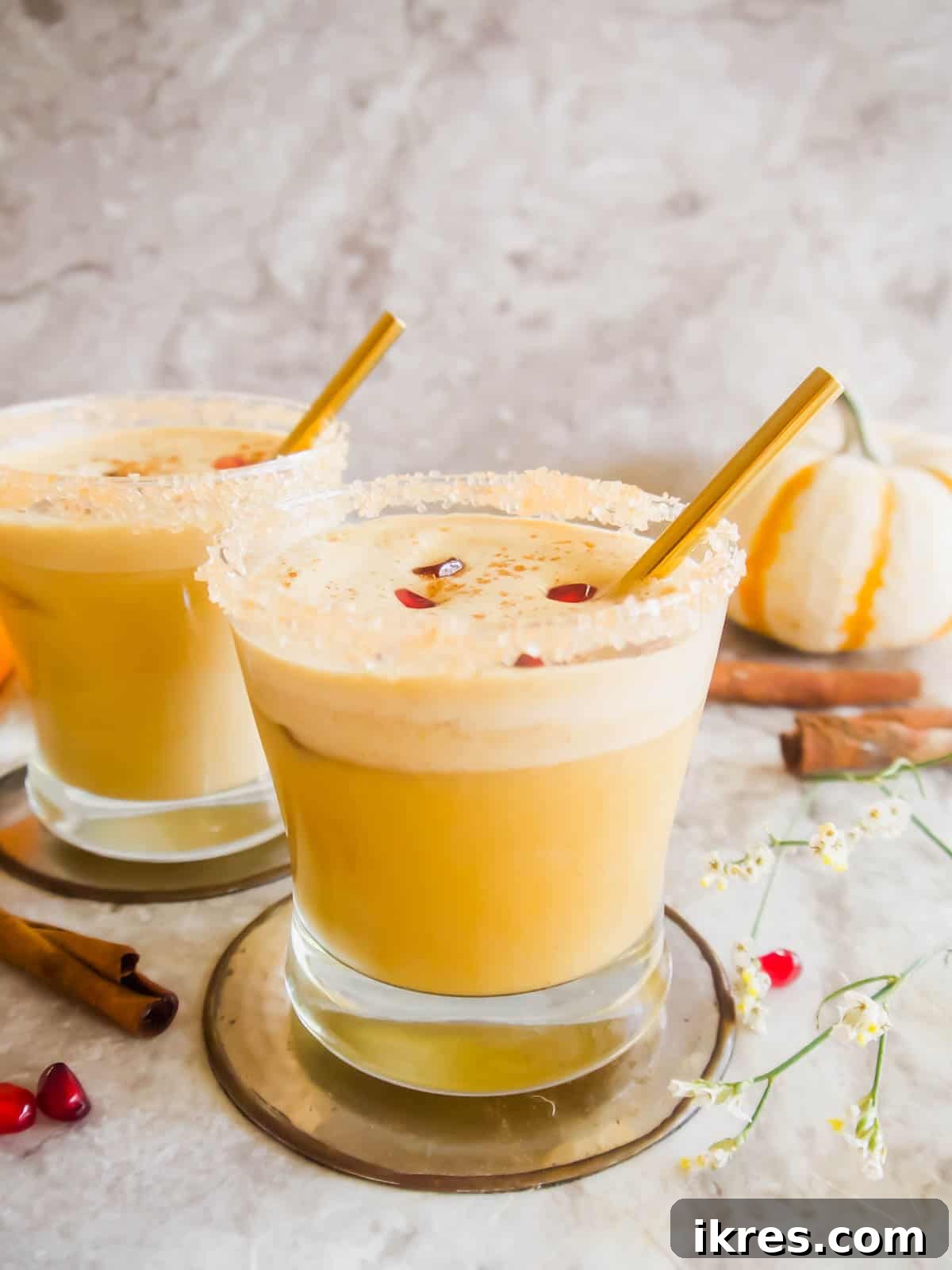 Two glasses of Pumpkin Spice White Russian, garnished for the Fall season, on a rustic background.