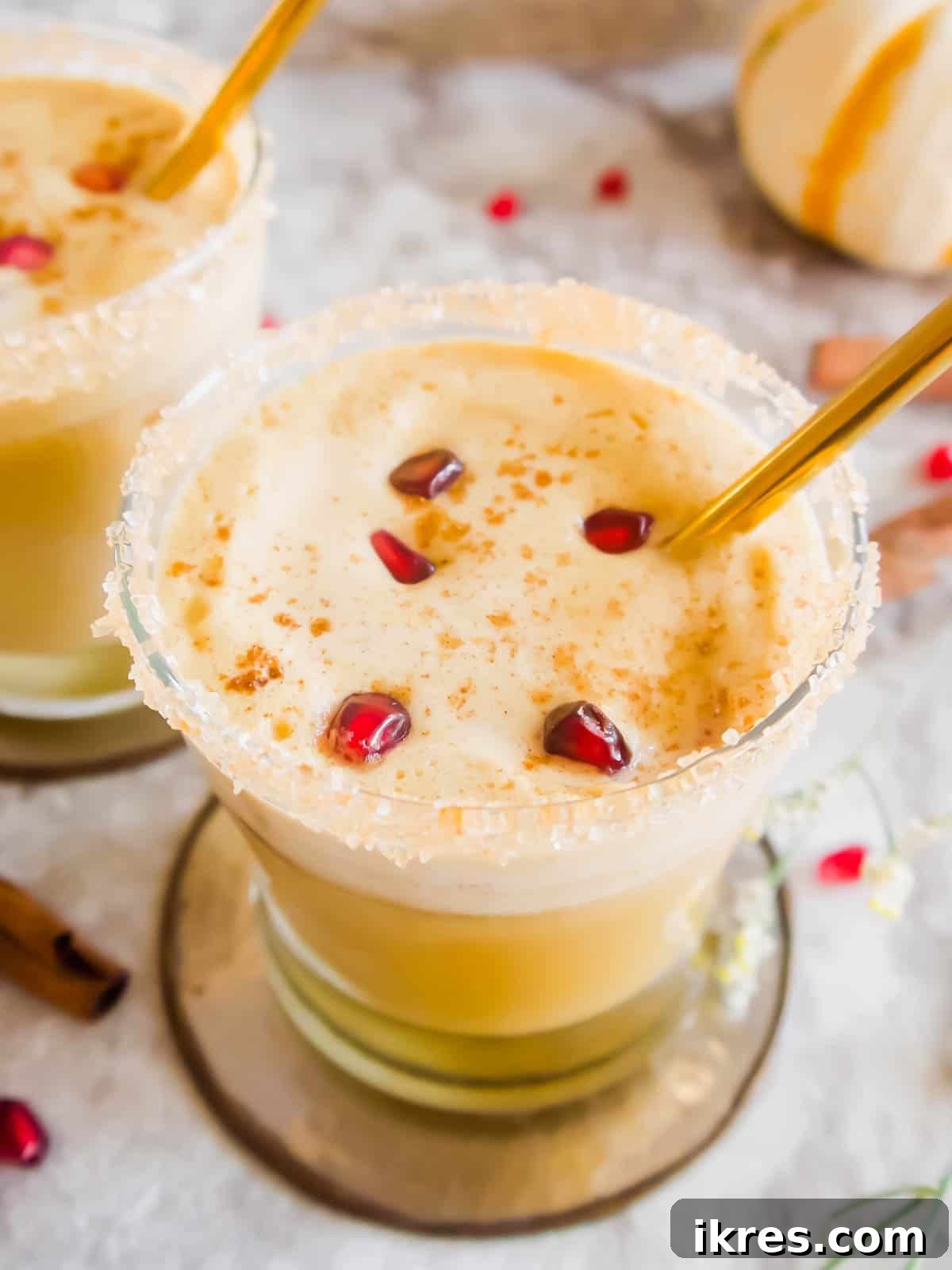 Fall White Russian cocktail in a garnished cup with pomegranate seeds, capturing the festive mood.