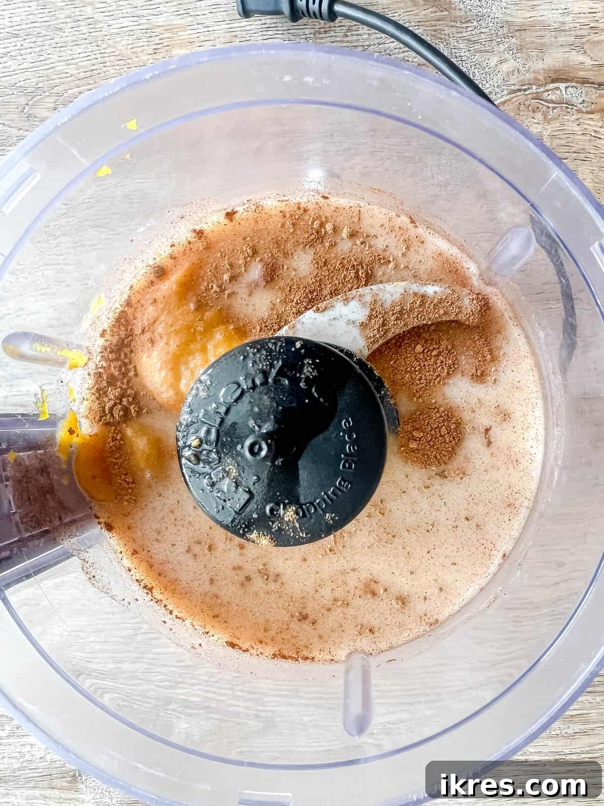 All pumpkin white Russian ingredients being added to a food processor for blending.