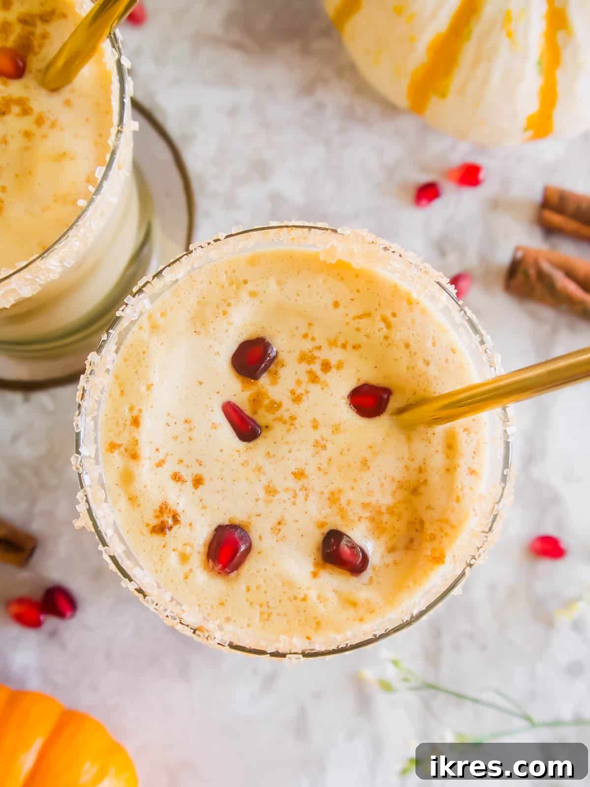 A festive pumpkin pie White Russian topped with a sprinkle of cinnamon, ready to be enjoyed.