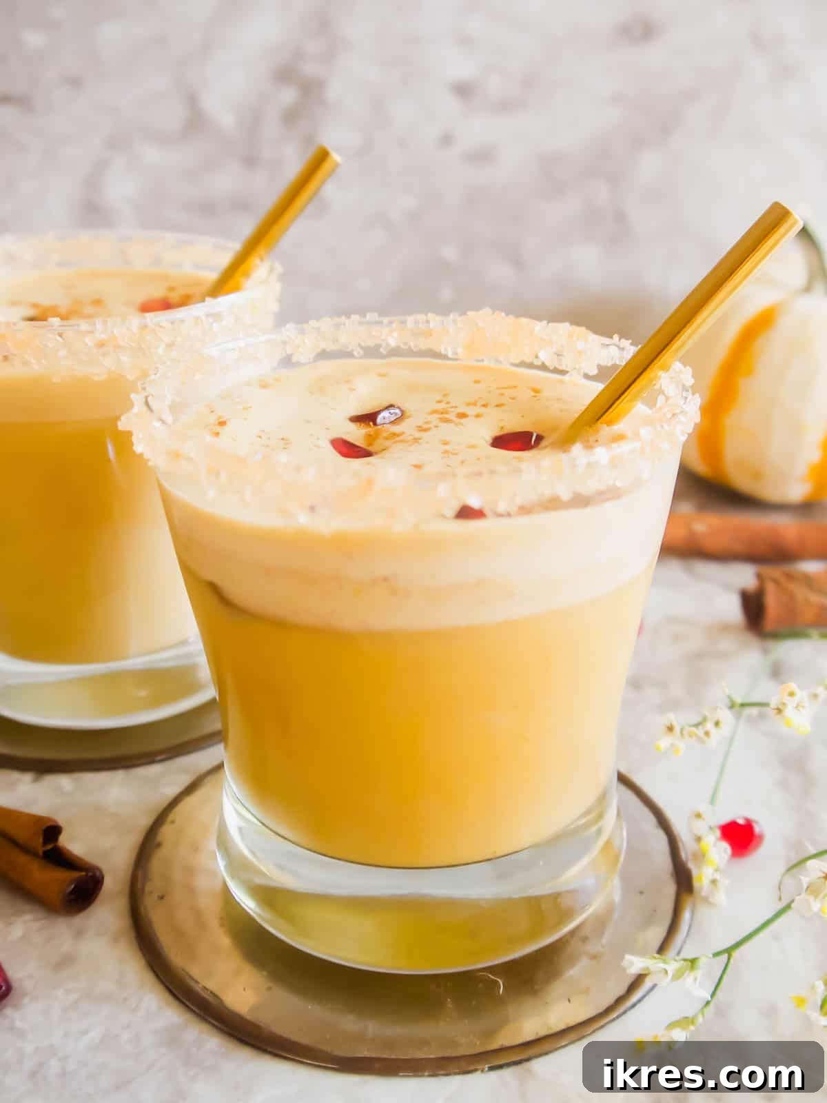 Pumpkin White Russian in a glass, beautifully rimmed with sugar, showcasing elegant presentation.