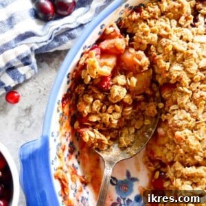 Spoon in baked pear oatmeal crisp.