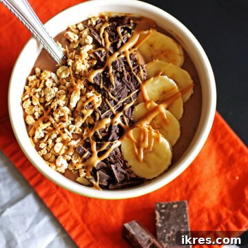 Creamy Chocolate Peanut Butter Smoothie Bowl with banana, chocolate, and granola toppings