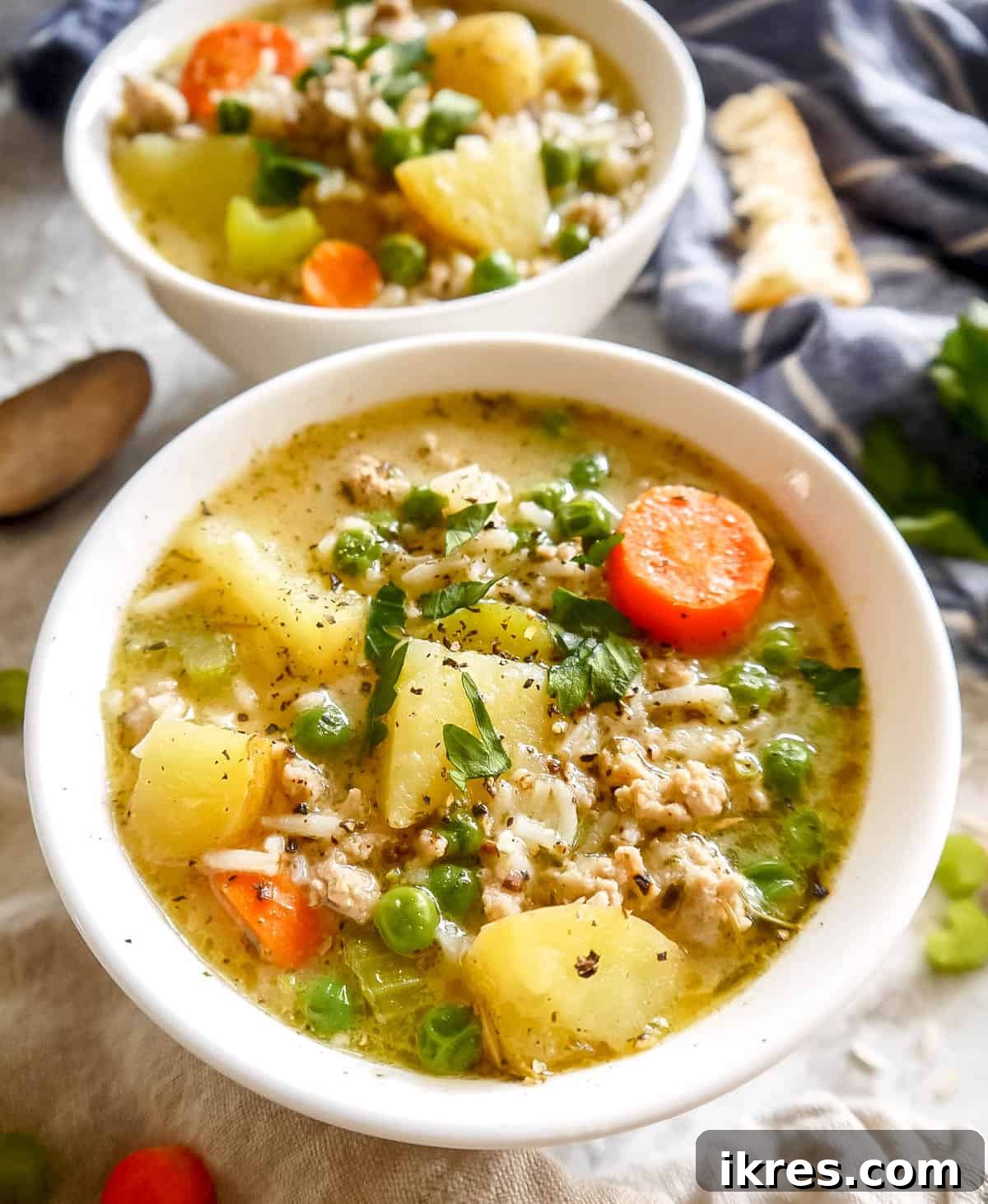 Up close photo of turkey soup showing potatoes, carrots, and ground turkey pieces.