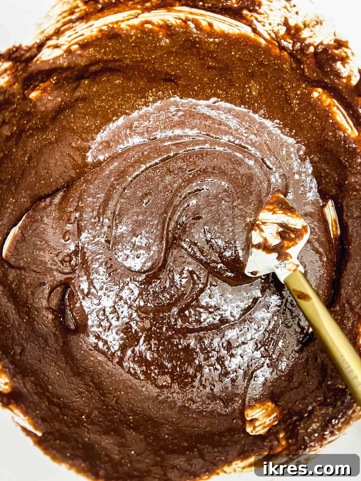 Deliciously Wholesome Almond Flour Brownies 10 Thick, glossy brownie batter, fully mixed and ready for baking, in a glass bowl.