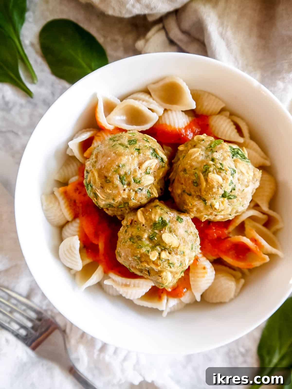 Lean & Green Baked Turkey Spinach Meatballs (Gluten-Free) 3 Turkey spinach meatballs served with pasta and rich tomato sauce, a classic pairing.