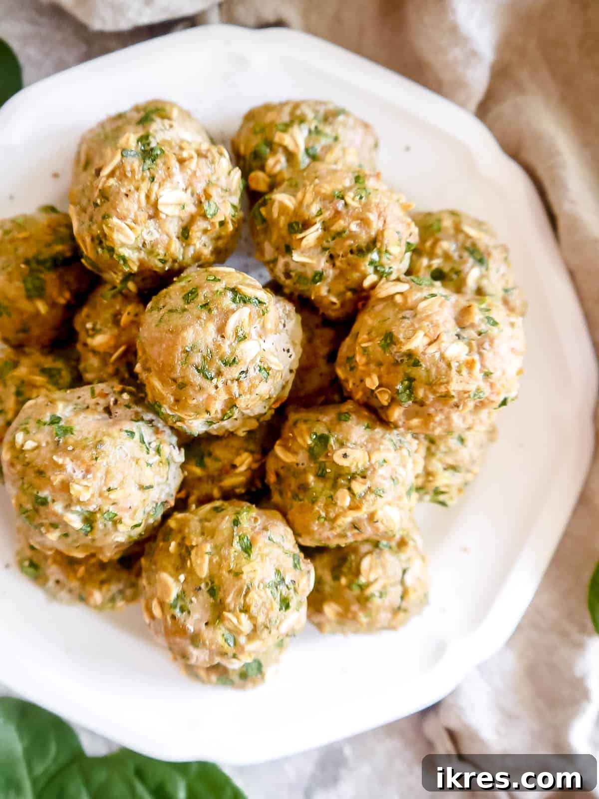 Lean & Green Baked Turkey Spinach Meatballs (Gluten-Free) 7 Close-up of baked turkey and spinach meatballs on a plate, ready to be enjoyed.
