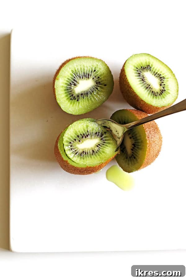 Refreshing Fruit Freezes 5 Scooping out the green kiwi using a spoon
