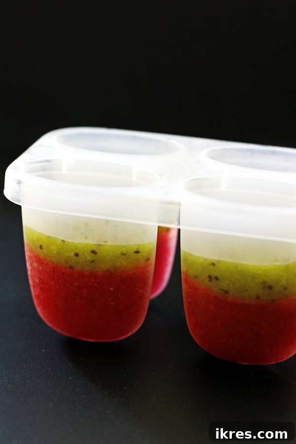 Refreshing Fruit Freezes 7 Popsicle molds partly filled with strawberry and kiwi puree