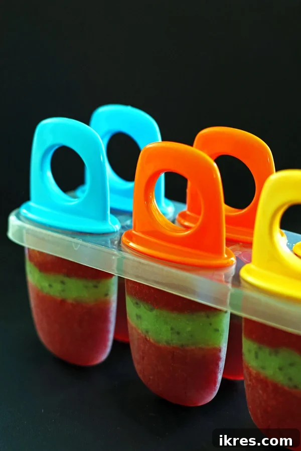 Refreshing Fruit Freezes 8 Popscile molds filled with strawberry, kiwi and strawberry puree