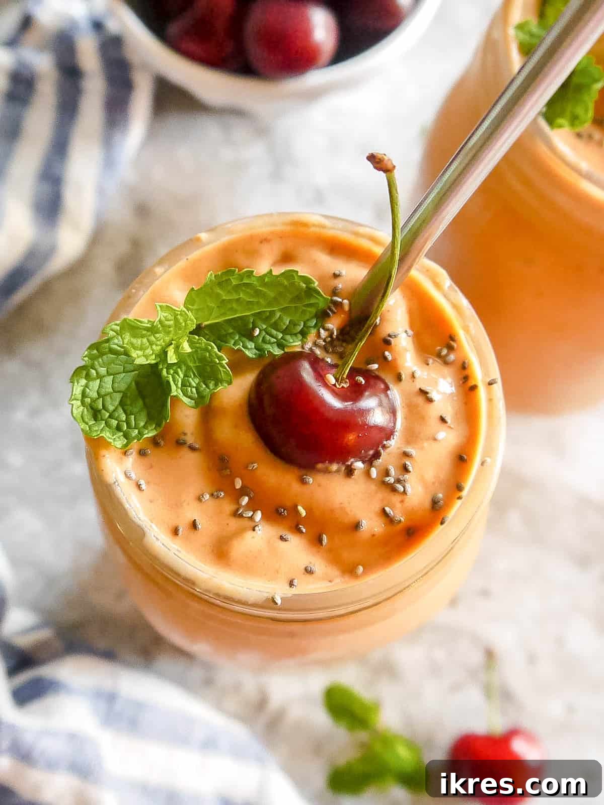 Creamy Cherry Mango Carrot Greek Yogurt Smoothie 3 Refreshing Cherry Mango Carrot Smoothie in a tall glass, highlighting its smooth, creamy texture.
