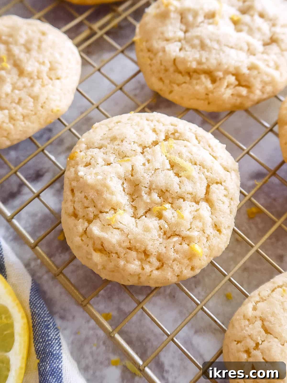Freshly baked Lemon Sugar Cookies with Olive Oil cooling on a wire rack after being removed from the oven.
