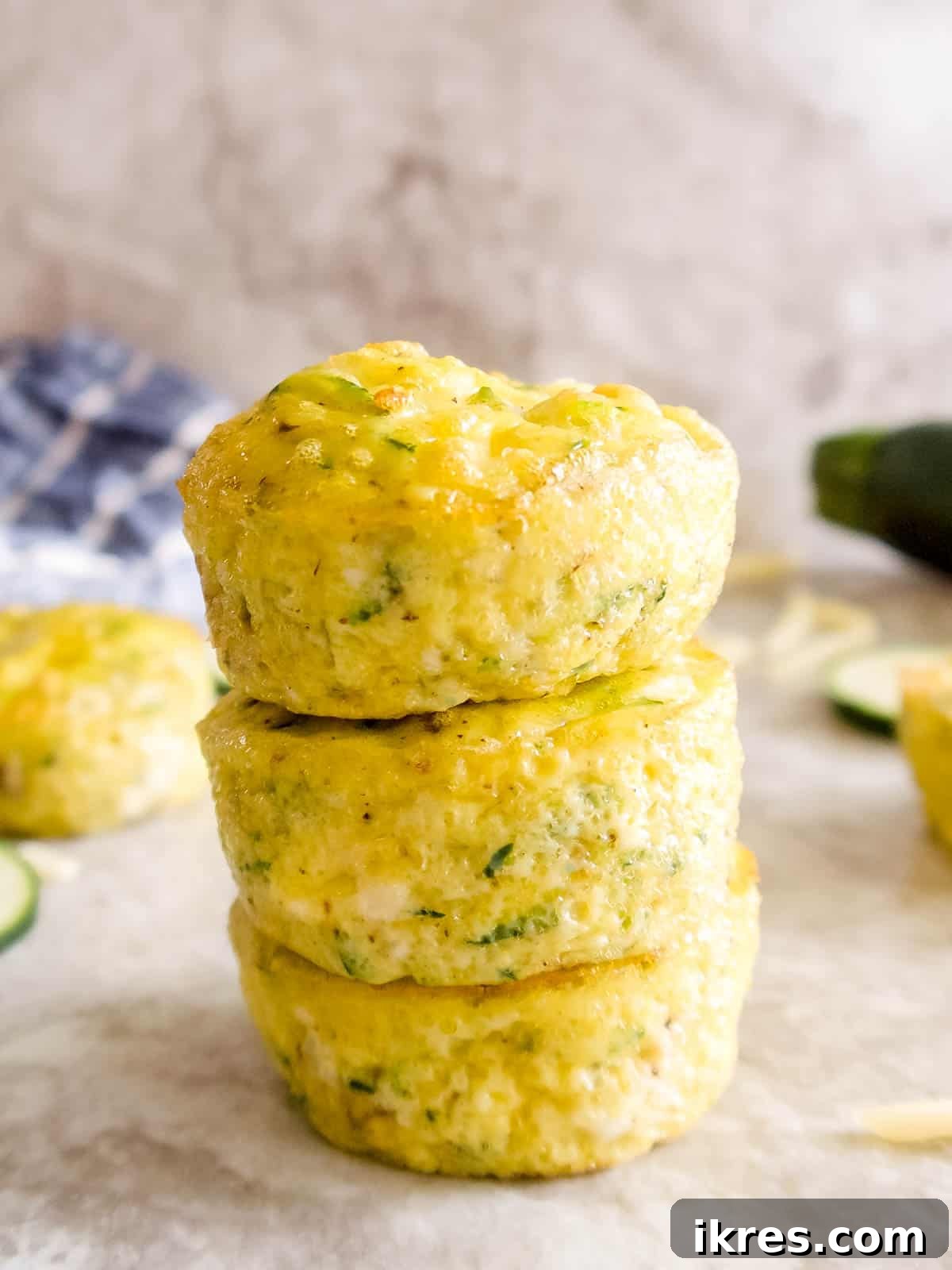 Zucchini egg muffins stacked on top of each other.