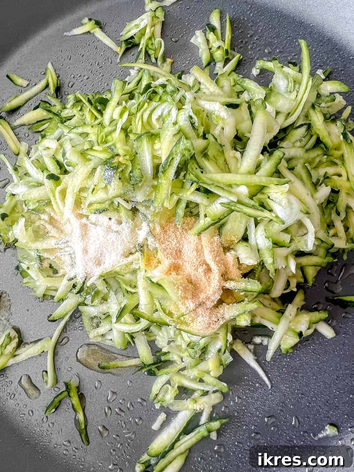 Shredded zucchini in a pan with spices.