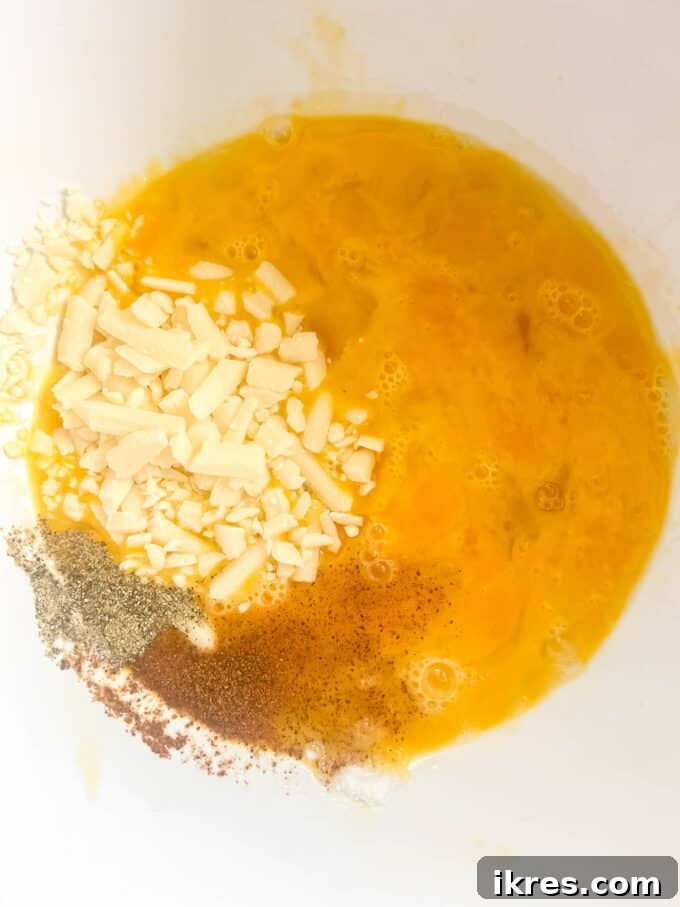 Cheese and spices added to the eggs.