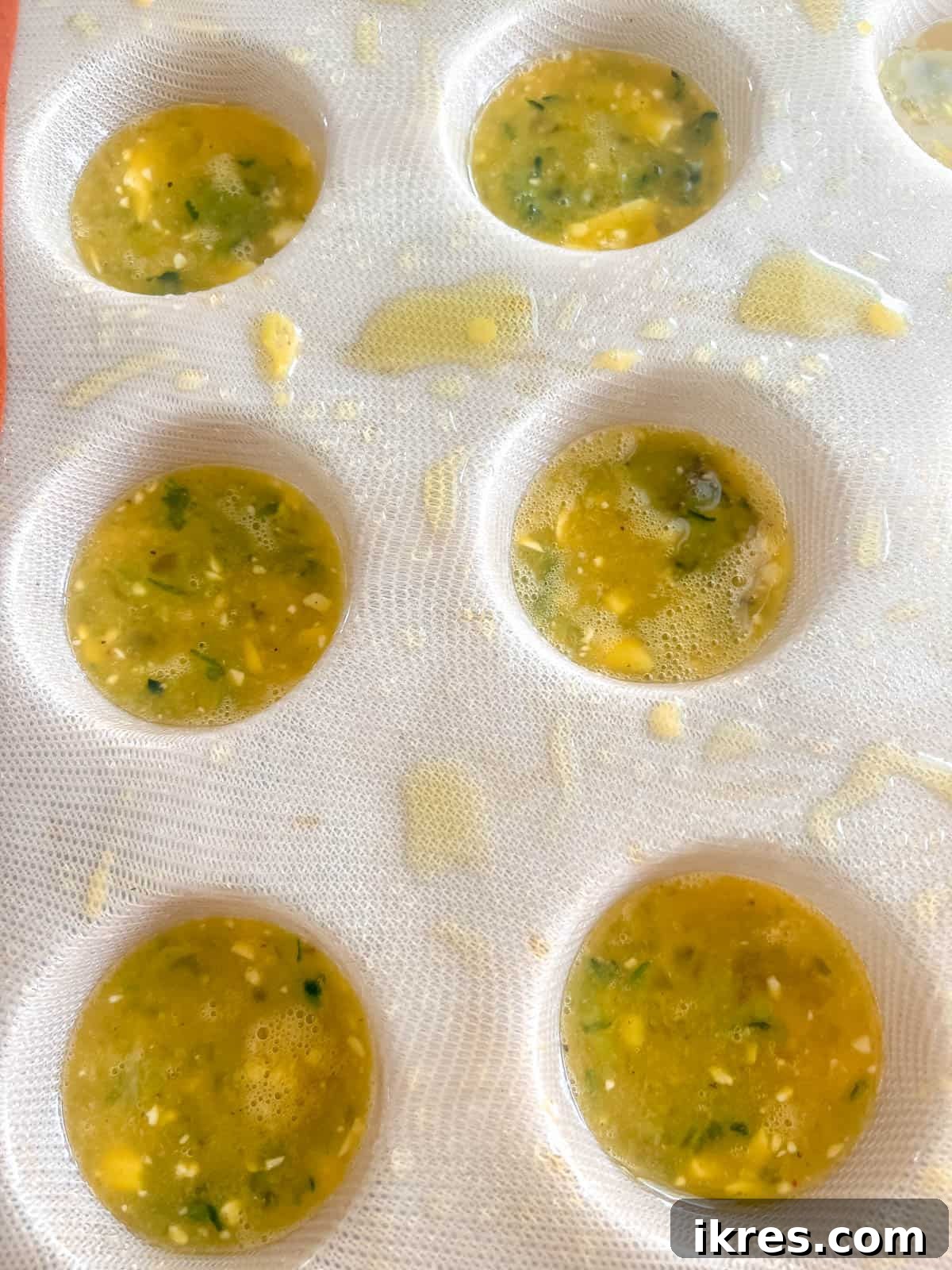 Egg mixture in silicone muffin tin.