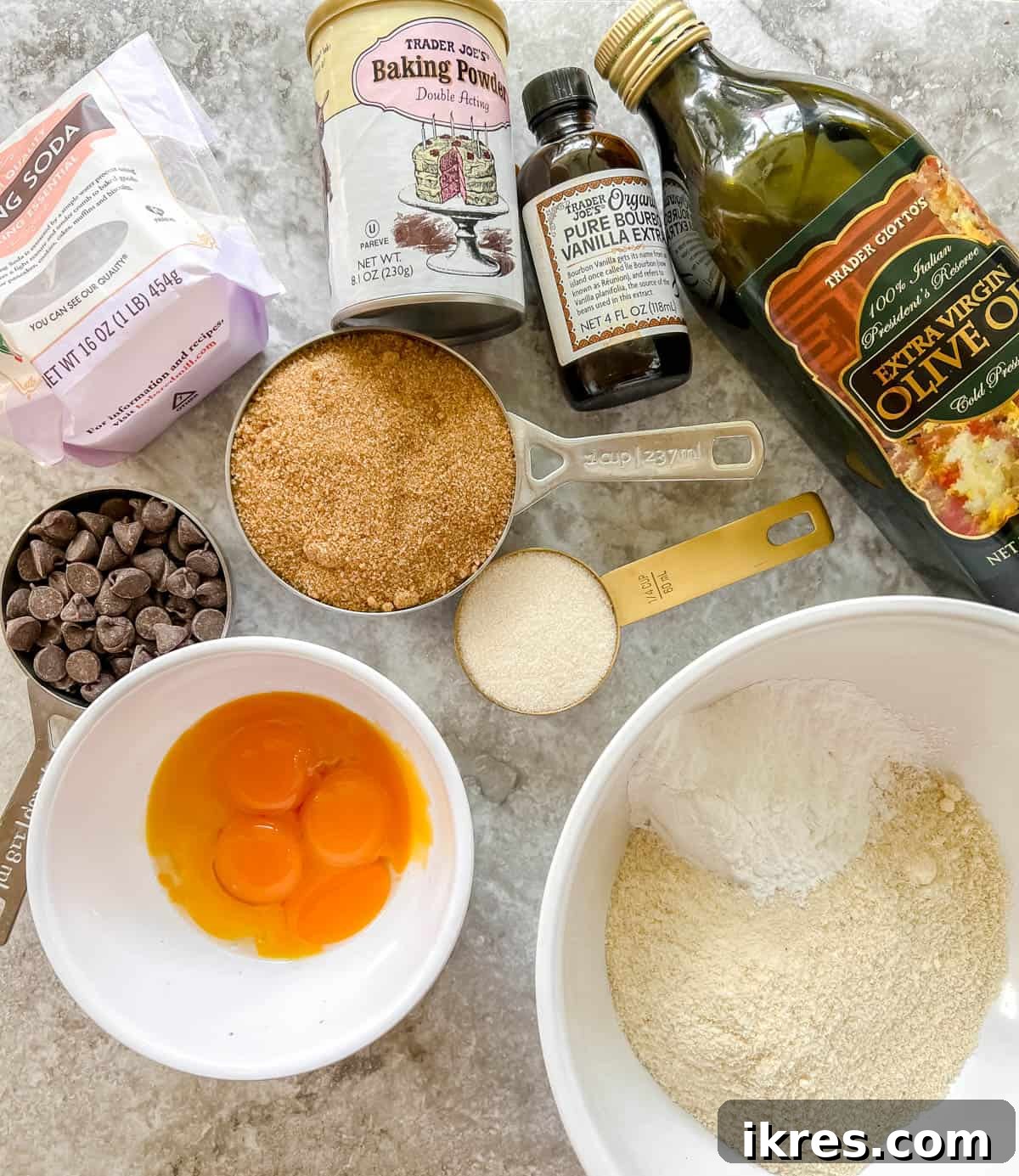 Golden Yolk Almond Chocolate Bars 4 Ingredients laid out for making almond flour egg yolk cookies, including oils, sugars, flours, and chocolate chips.