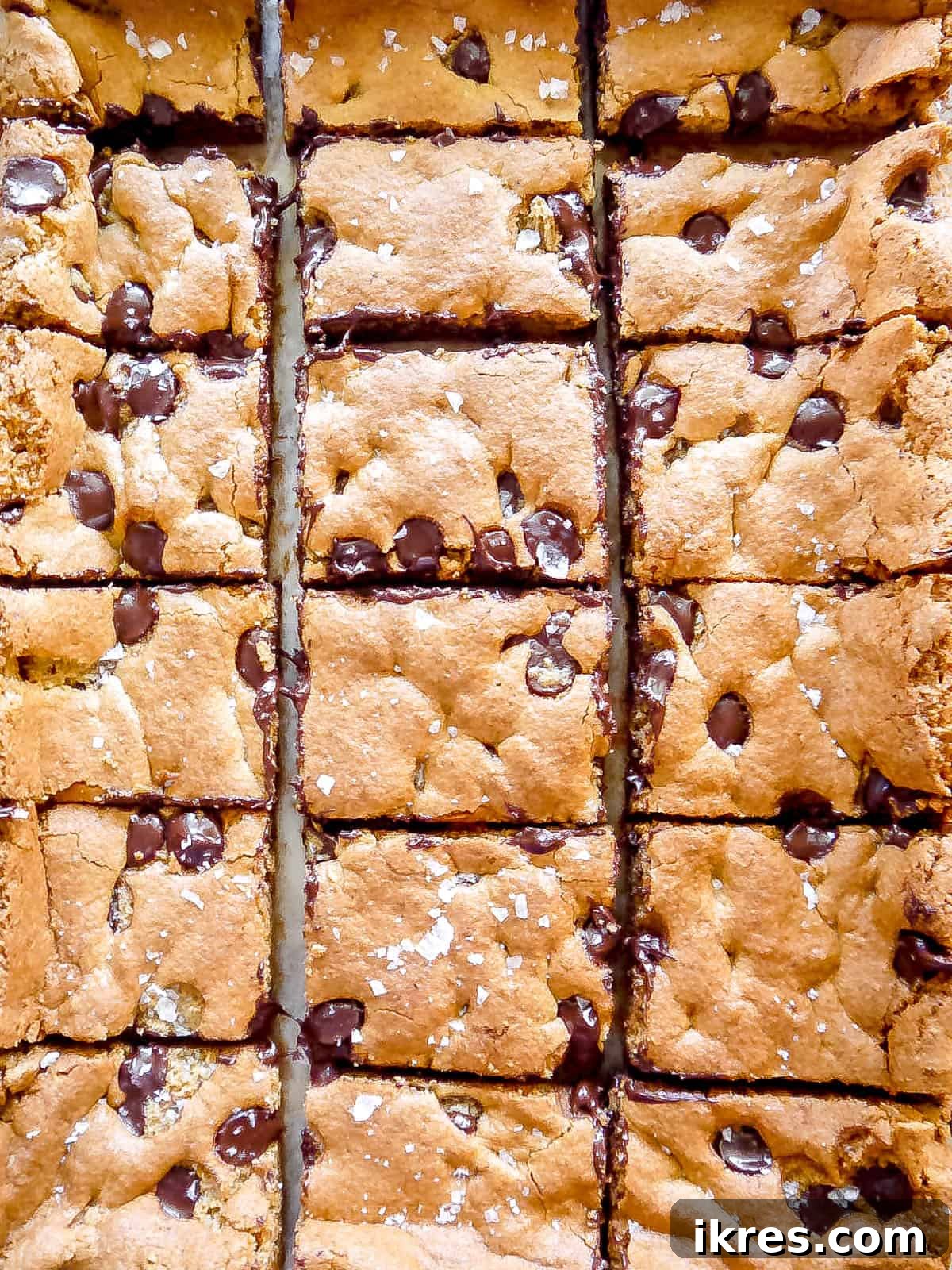 Golden Yolk Almond Chocolate Bars 9 Freshly cut dairy-free chocolate chip cookie bars on a cutting board.