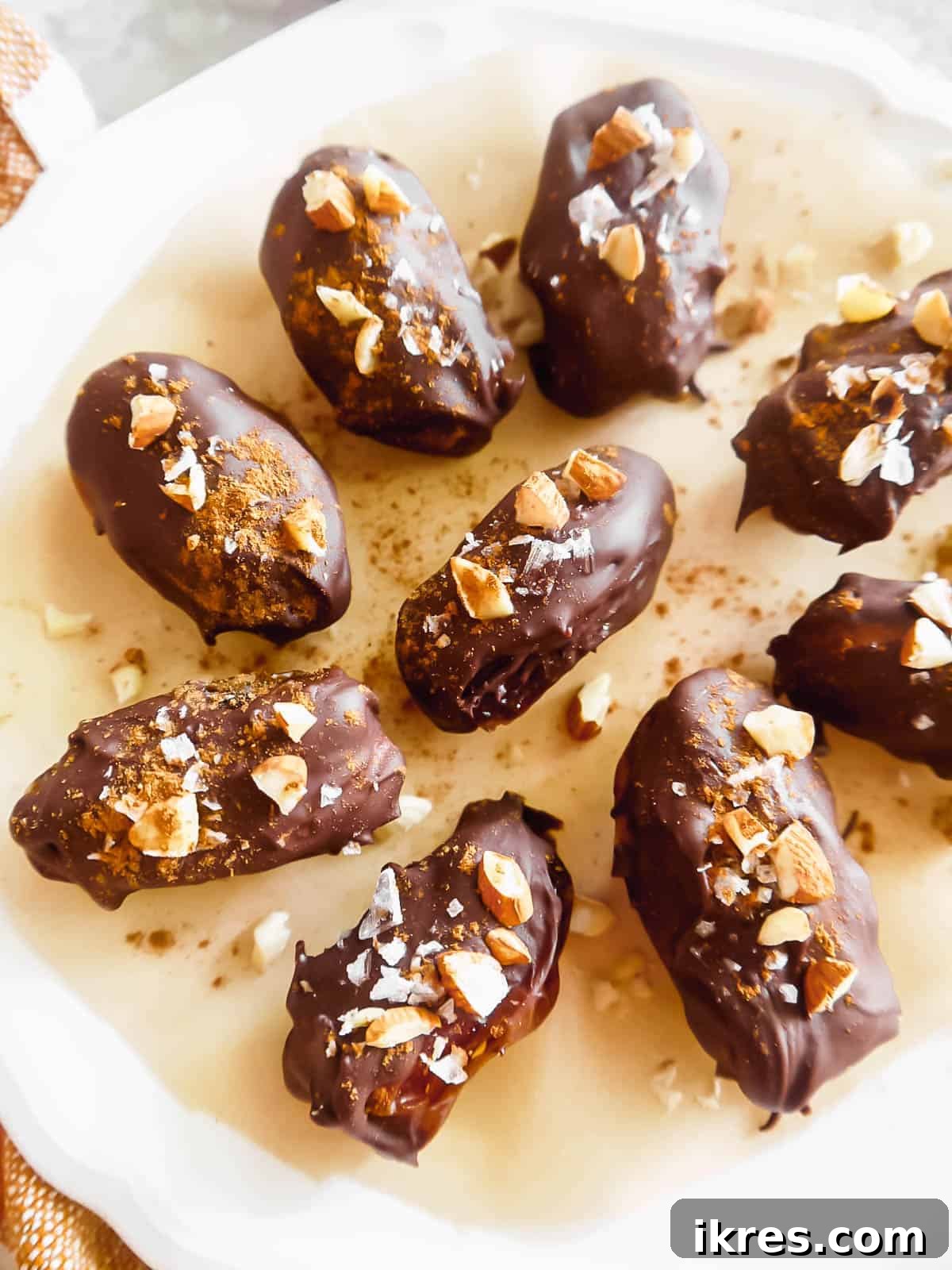 Chocolate Covered Pumpkin Stuffed Dates on a plate, ready to be enjoyed.