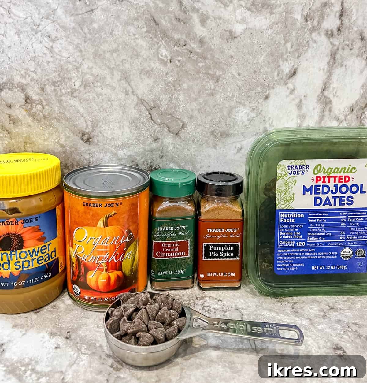 Ingredients needed to make pumpkin stuffed dates, including dates, pumpkin puree, sunflower seed butter, and chocolate chips.