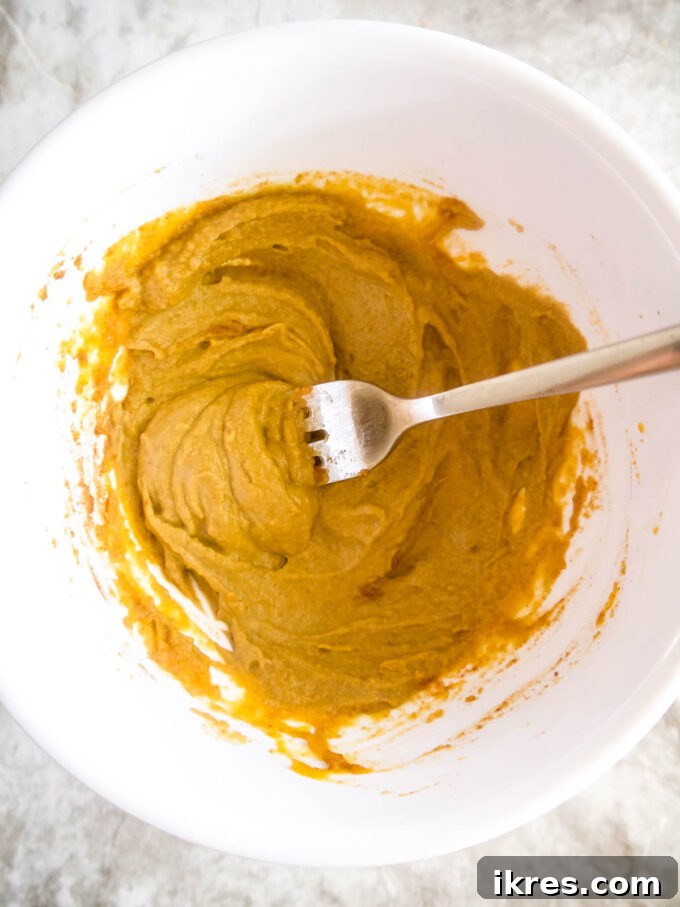 Bowl with pumpkin, sunflower seed butter, and spices mixed together.
