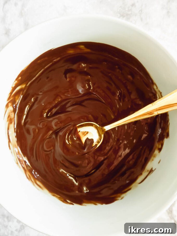 Bowl of melted dairy-free chocolate with oil.