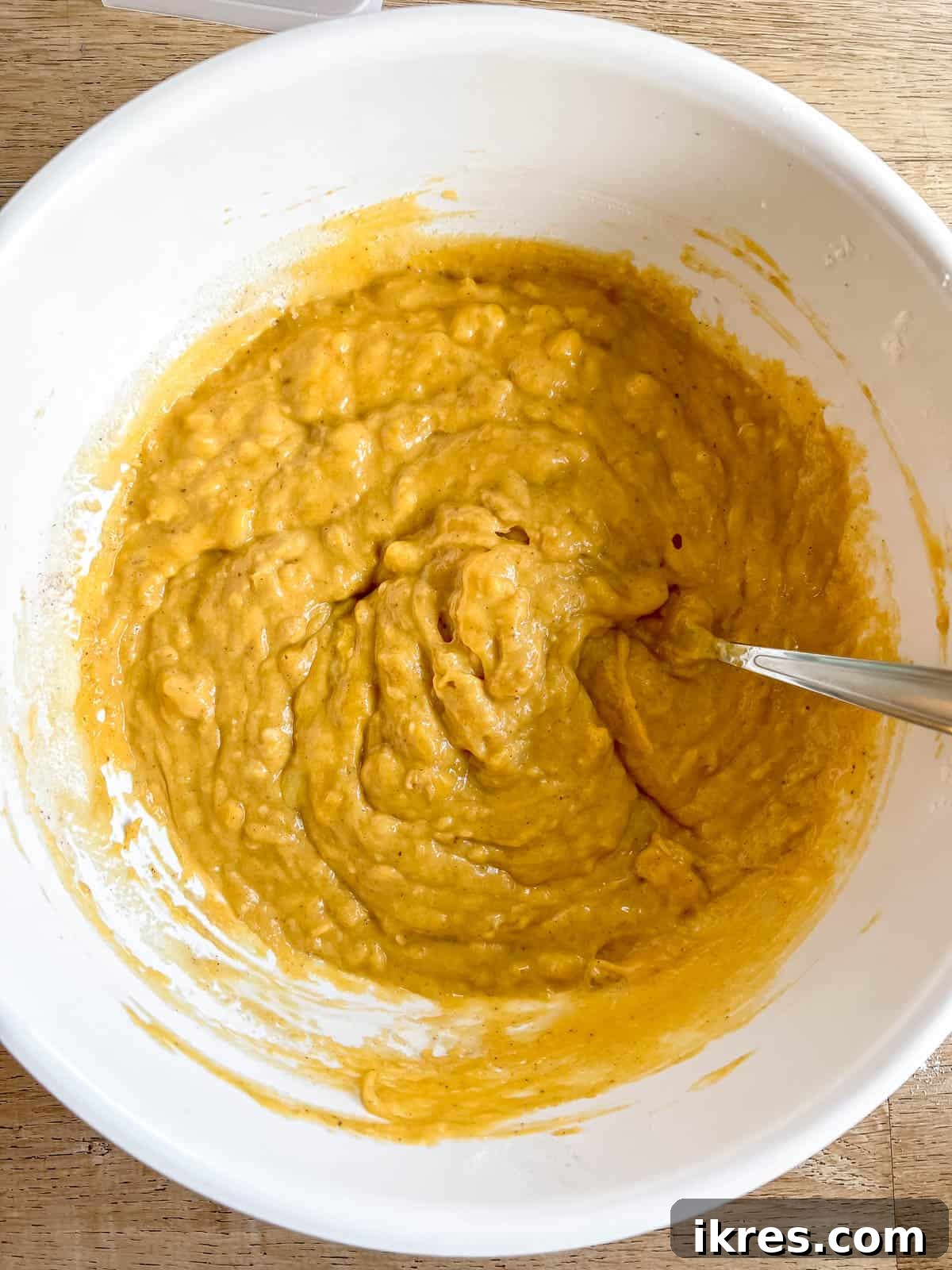 Fully mixed pumpkin banana bread batter in a single bowl.