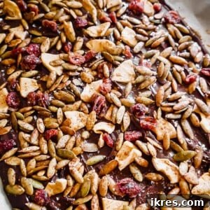 Autumn Orchard Chocolate Bark with Pepita Crunch 10 Fall Chocolate Bark with Dried Apples and Roasted Pepitas in pan, cut into pieces