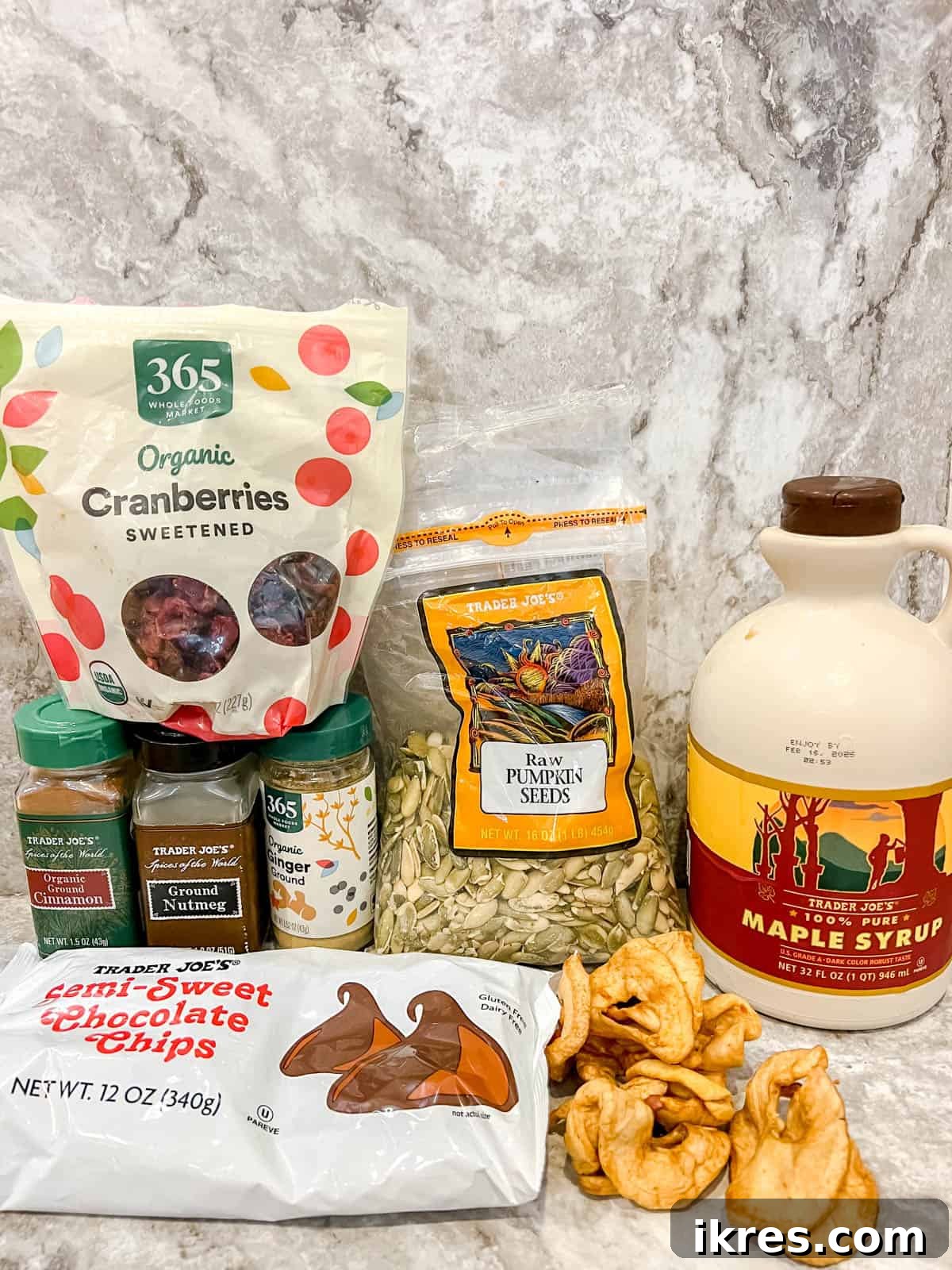 Autumn Orchard Chocolate Bark with Pepita Crunch 4 A vibrant collection of fresh ingredients for making Fall chocolate bark, including dried apples, green pepitas, and an assortment of spices.