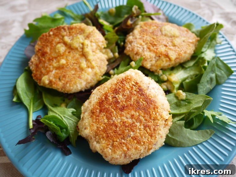 Crispy Golden Lemon Thyme Fish Cakes 2 Paleo Crispy Lemon-Thyme Fish Cakes (GF) - a restaurant-quality way to eat healthy fish. A close-up shot showing the golden-brown crispy crust and fresh thyme garnish.