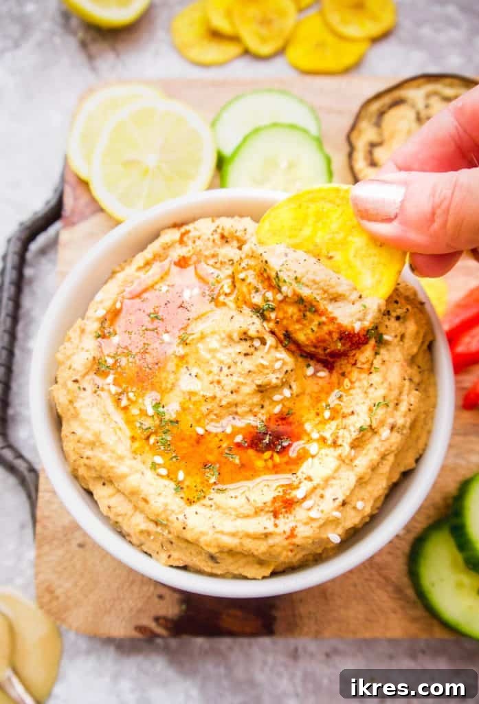 The perfectly roasted vegetables along with tahini, lemon juice, and spices are placed into a blender, ready to be transformed into creamy hummus.