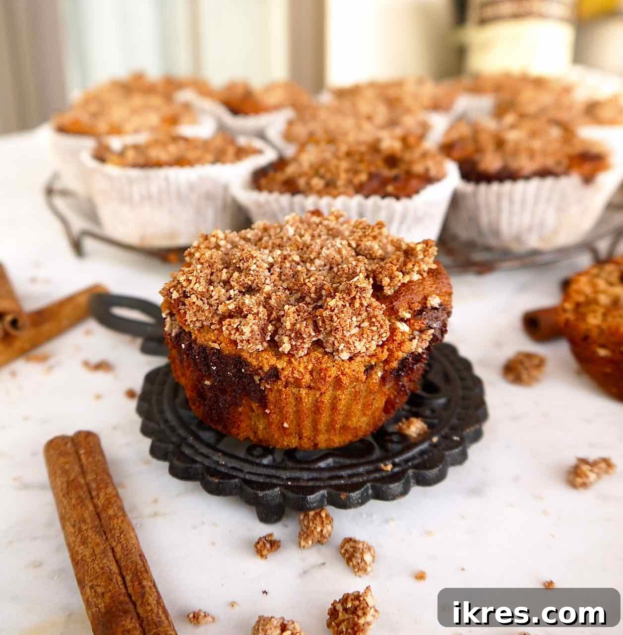 Gluten-Free Cinnamon Swirl Coffee Cake Muffins 4 Freshly baked gluten-free coffee cake muffins cooling on a wire rack, ready to be enjoyed