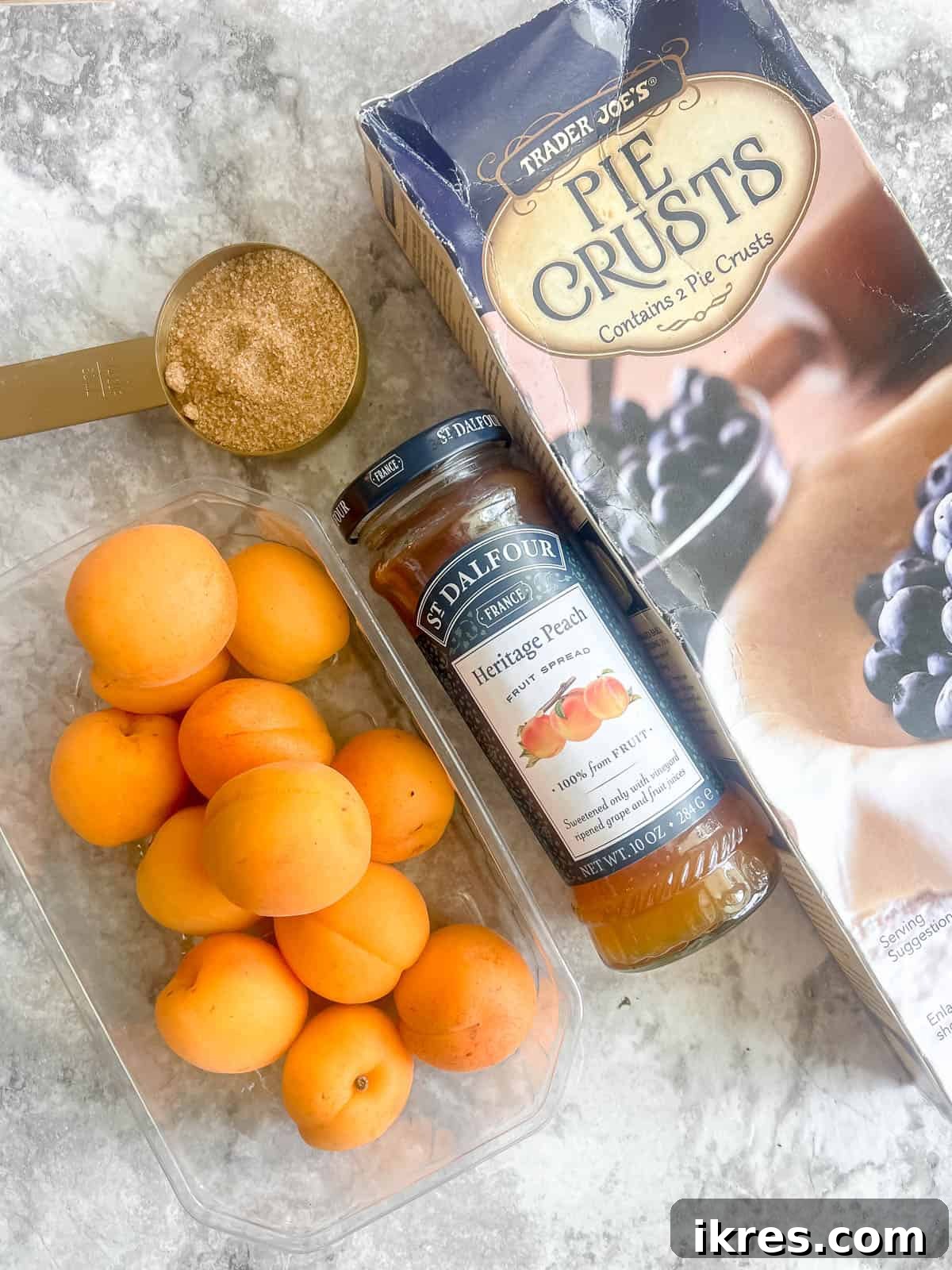 No-Fuss Apricot Tart with Premade Pastry 3 All the simple ingredients laid out for making tarte aux abricots: a store-bought pie crust, jam, rolled oats, brown sugar, and fresh apricots.