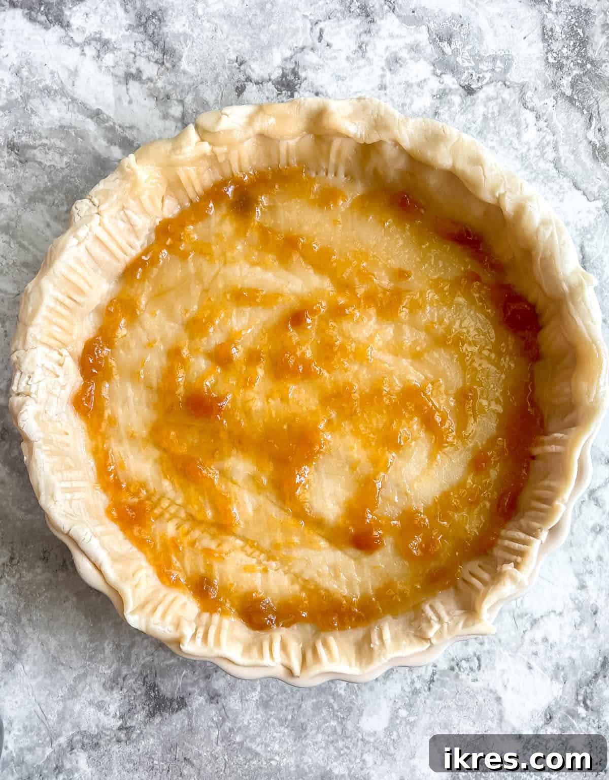 No-Fuss Apricot Tart with Premade Pastry 6 A smooth, even layer of peach or apricot jam spread across the bottom of the pie crust.