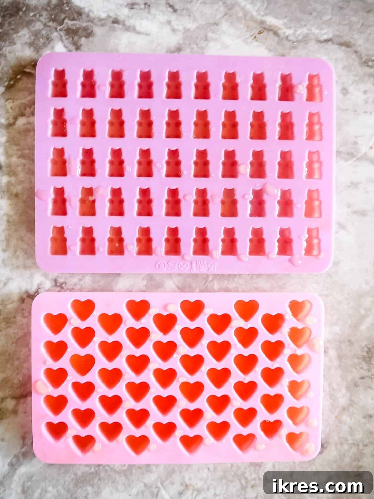 DIY Apple Gummy Delights 7 Apple gelatin mixture being poured into silicone gummy molds.