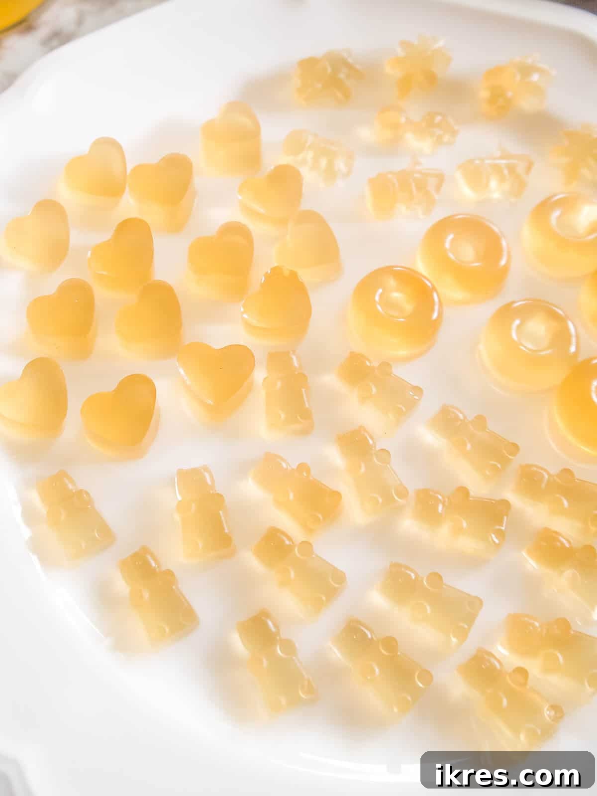 DIY Apple Gummy Delights 8 Set apple juice gummies removed from molds and arranged on a plate.