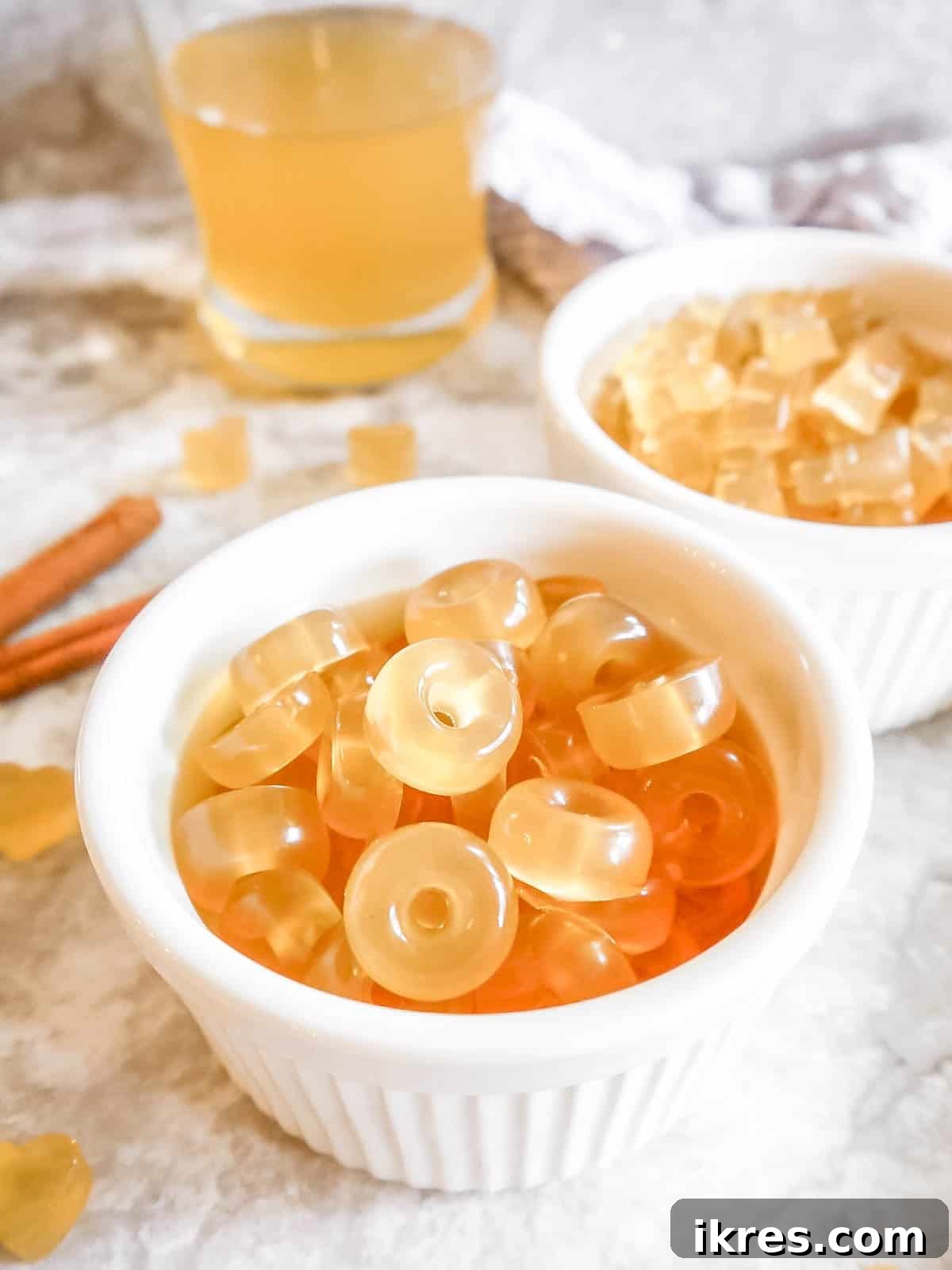DIY Apple Gummy Delights 9 Two bowls overflowing with homemade gummy candy made with apple juice and gelatin.