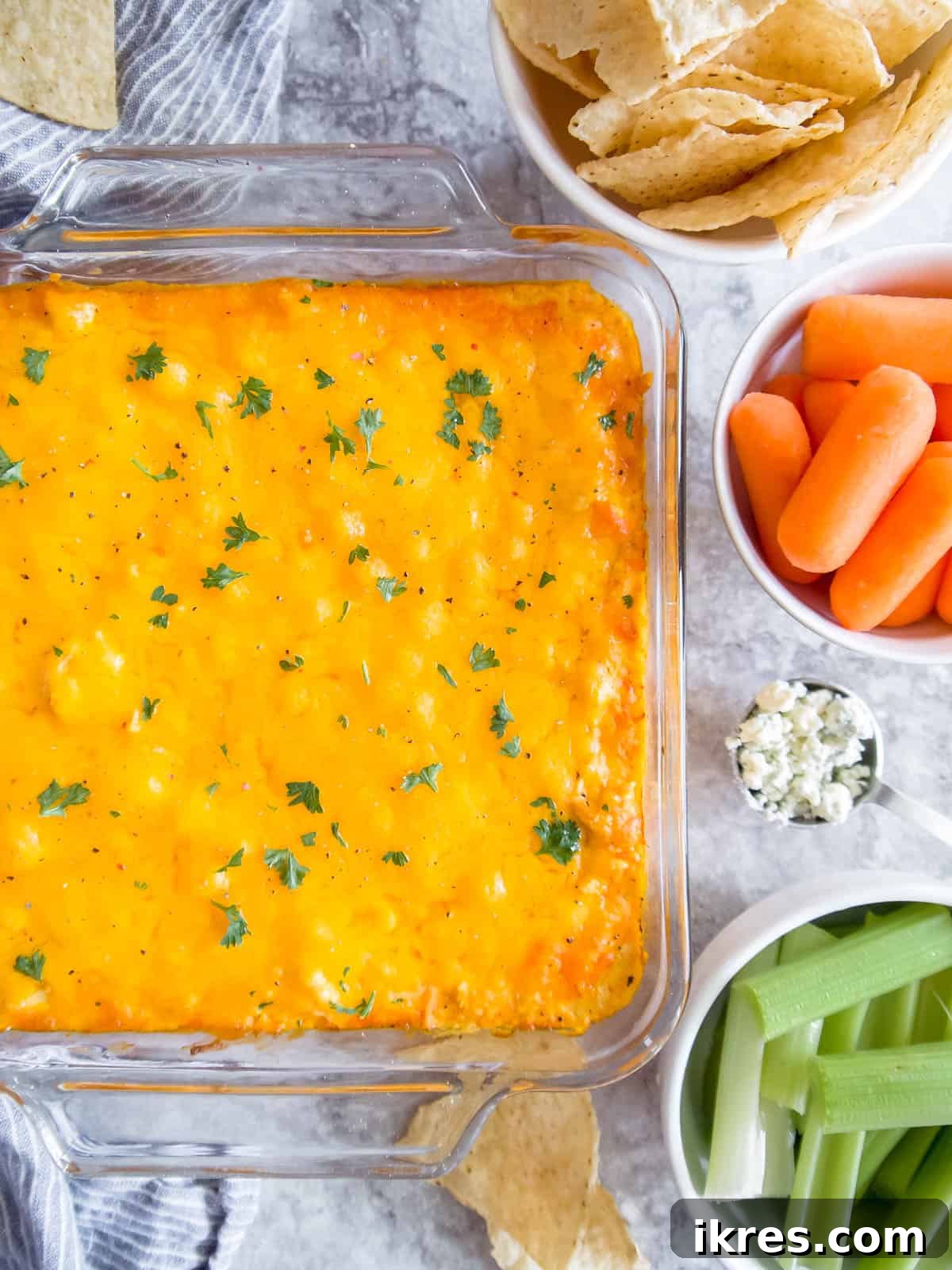 Baked buffalo chicken dip with canned chicken, fresh out of the oven, golden and bubbly, with a golden crust of cheese.