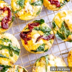 Mediterranean Spinach Feta Egg Muffins 11 Spinach feta egg cups cooling on a drying rack.