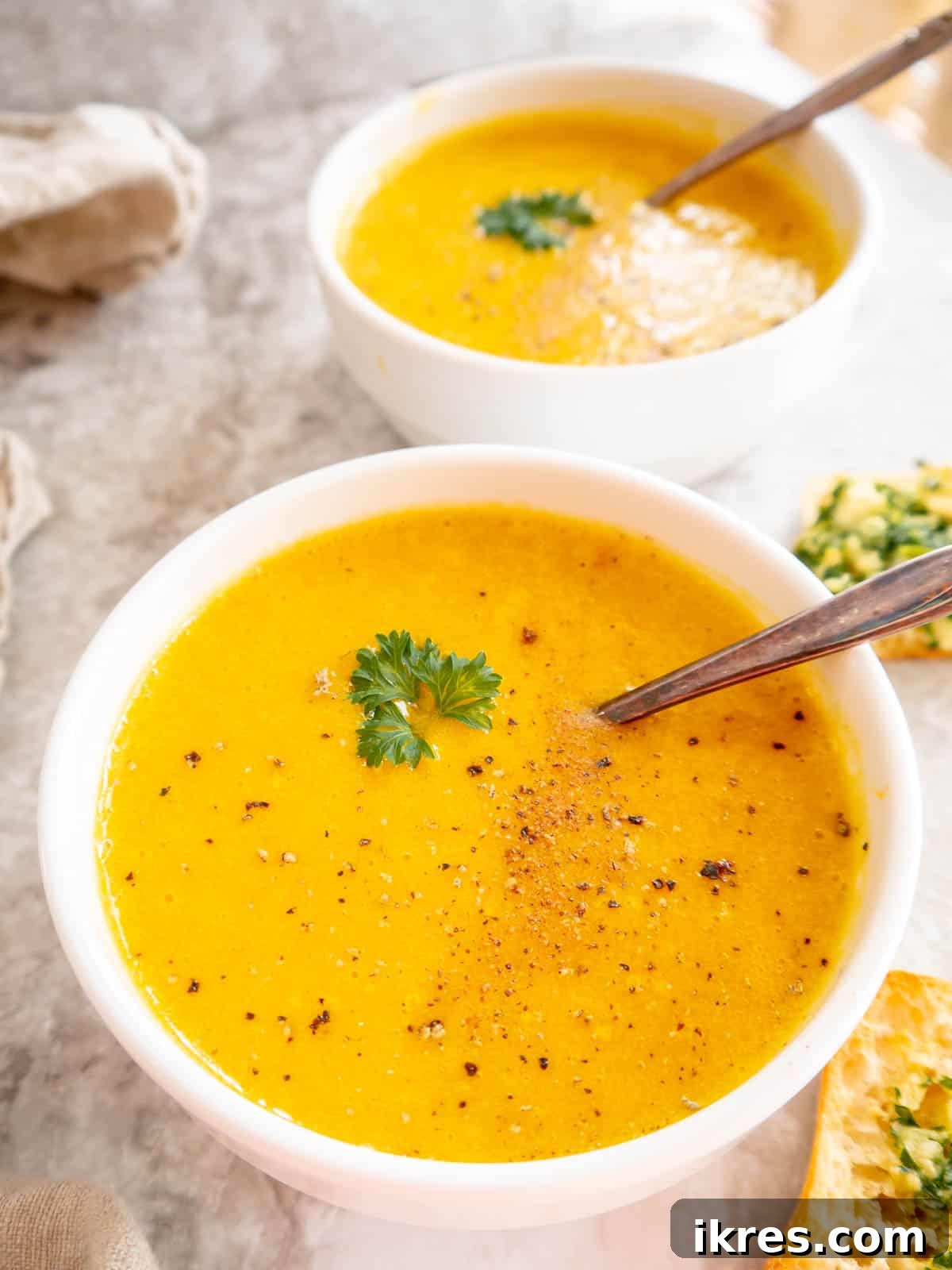 High protein butternut squash soup in two bowls.