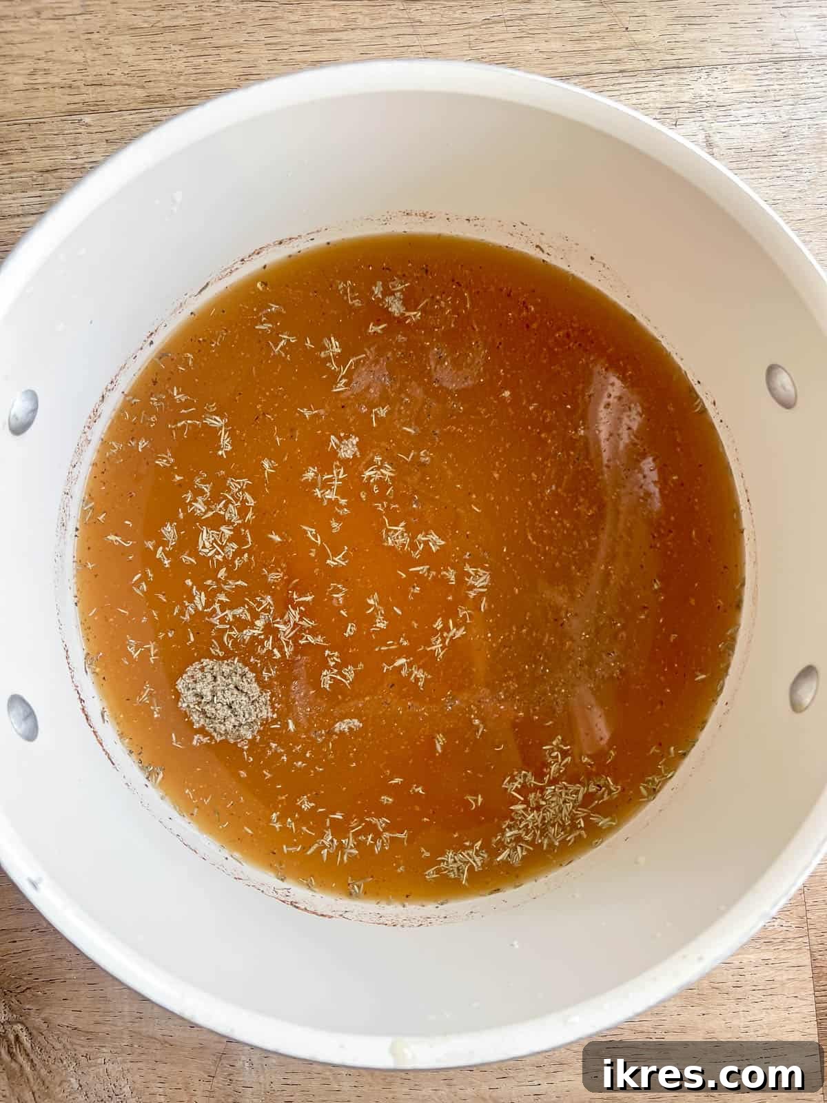 Bone broth in a soup pan.