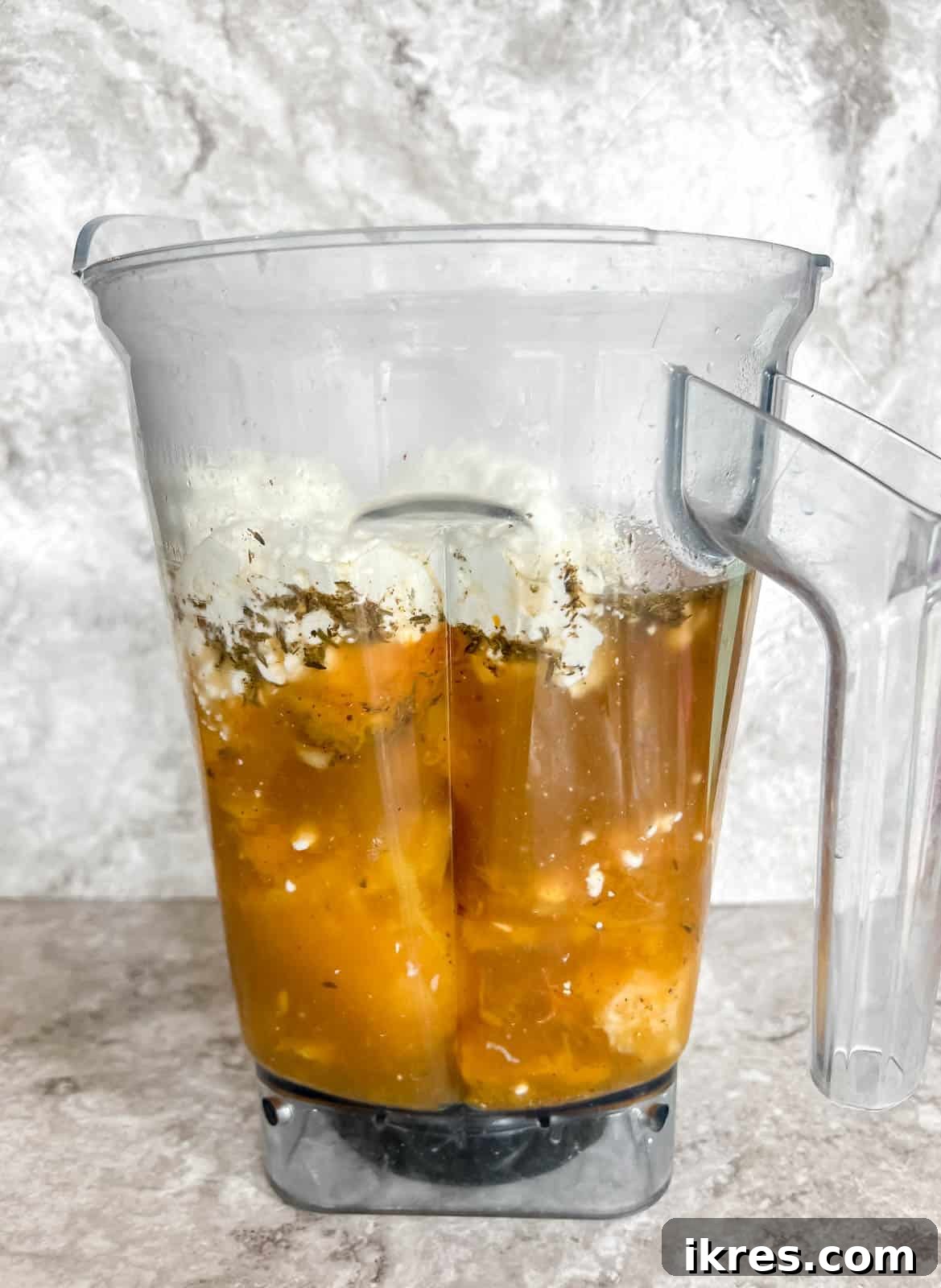 Bone broth butternut squash soup ingredients in a blender.