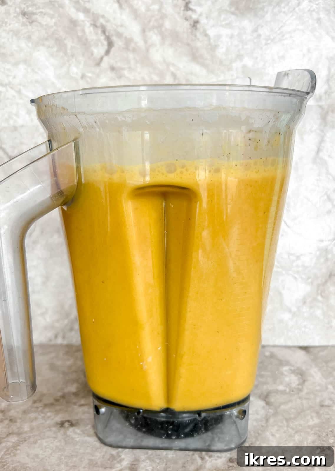 Healthy butternut squash soup in a blender after mixed.