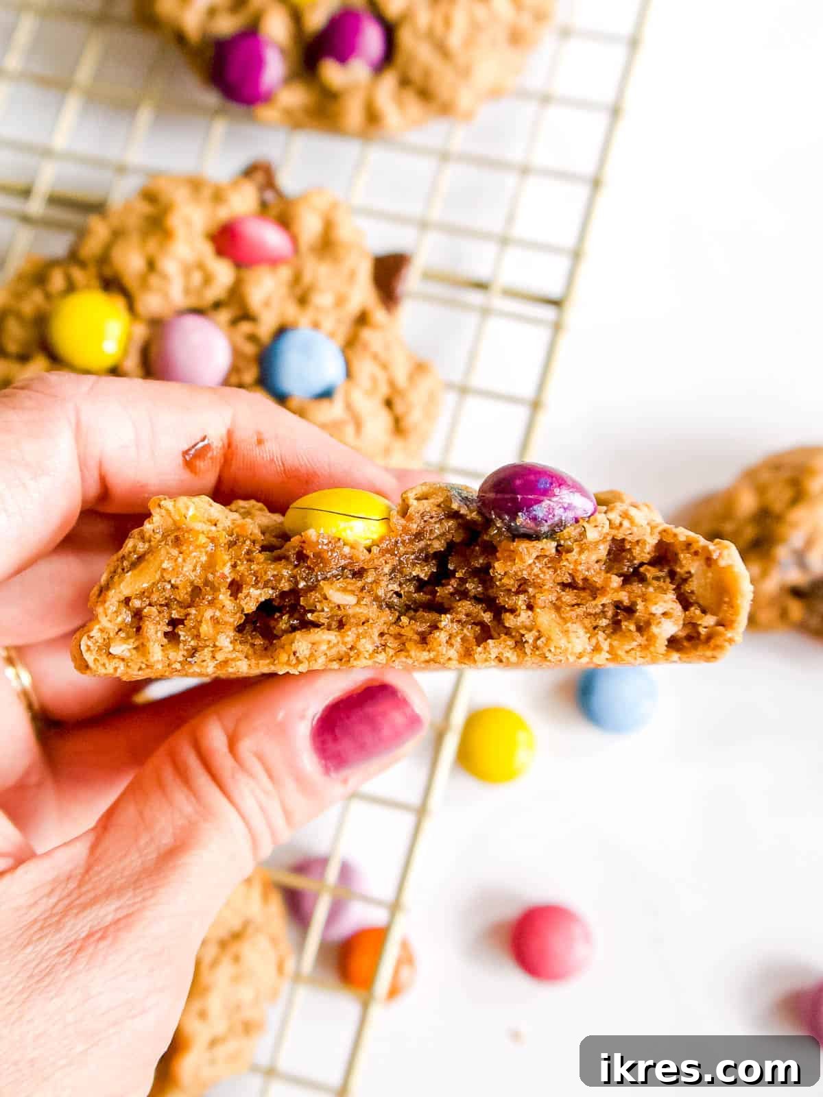 A healthy monster cookie with a bite taken out, revealing its soft, chewy interior and melty chocolate.