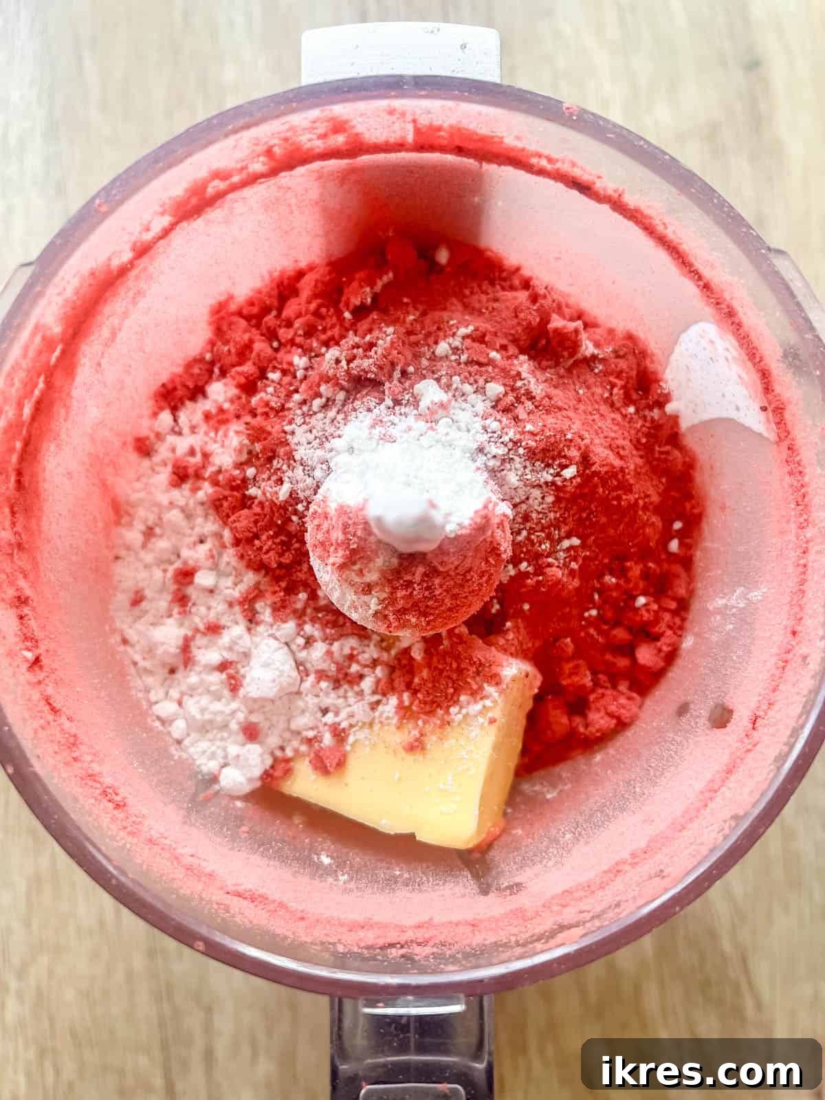 Homemade Small Batch Strawberry Cupcakes 11 Strawberry frosting ingredients including softened butter, powdered sugar, and strawberry powder in a food processor.