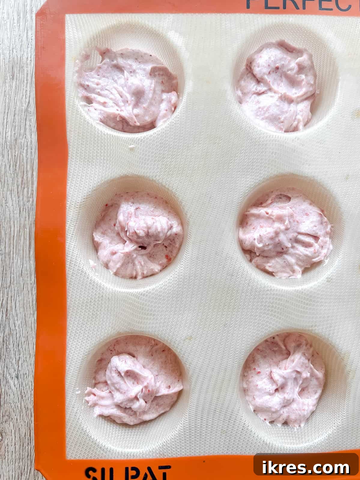 Homemade Small Batch Strawberry Cupcakes 9 Strawberry cupcake batter evenly distributed into six muffin tins, ready for baking.