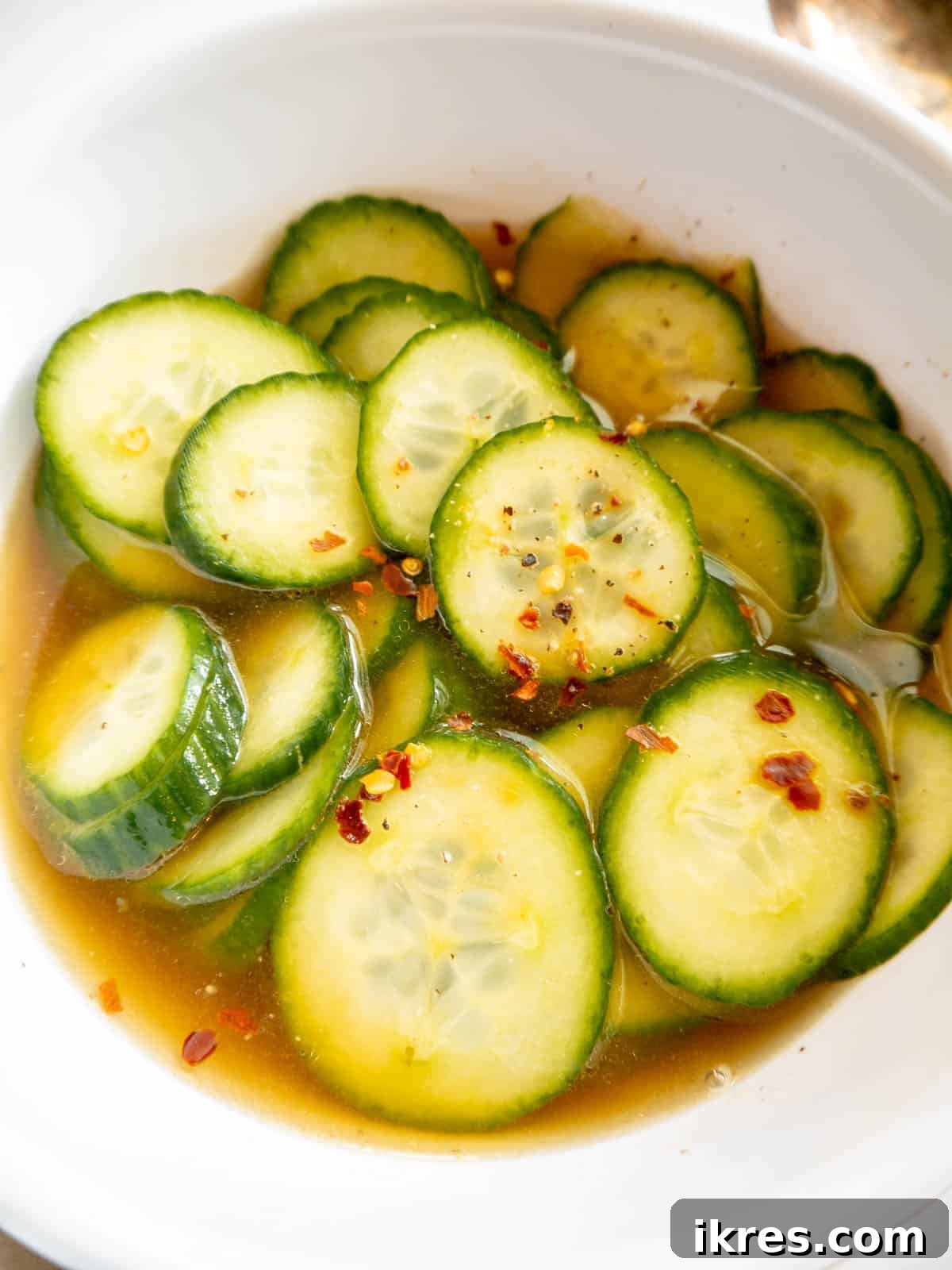 Crisp Asian Quick Pickles 6 Quick pickled cucumbers resting in the pickling liquid at room temperature for 15 minutes, allowing flavors to meld.