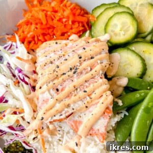 Fresh salmon rice bowl with spicy mayo on top, presented beautifully.